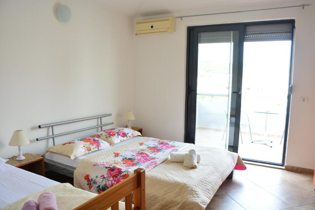 a bedroom with two beds with a stuffed animal on the bed at NEXT DOOR HOUSE in Ulcinj