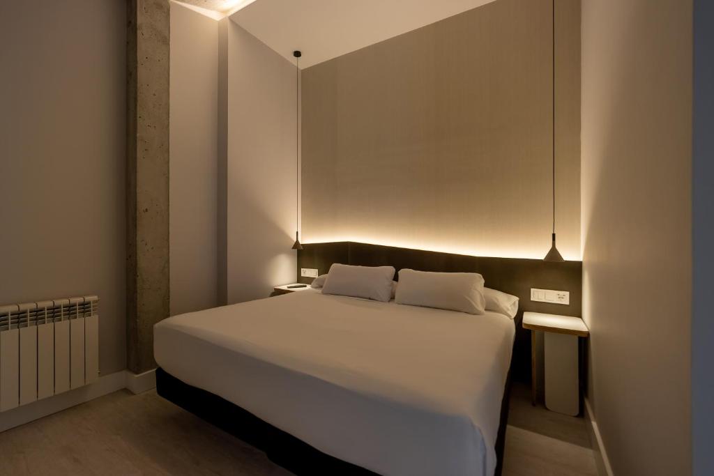 A bed or beds in a room at A de Loló Alojamiento con encanto
