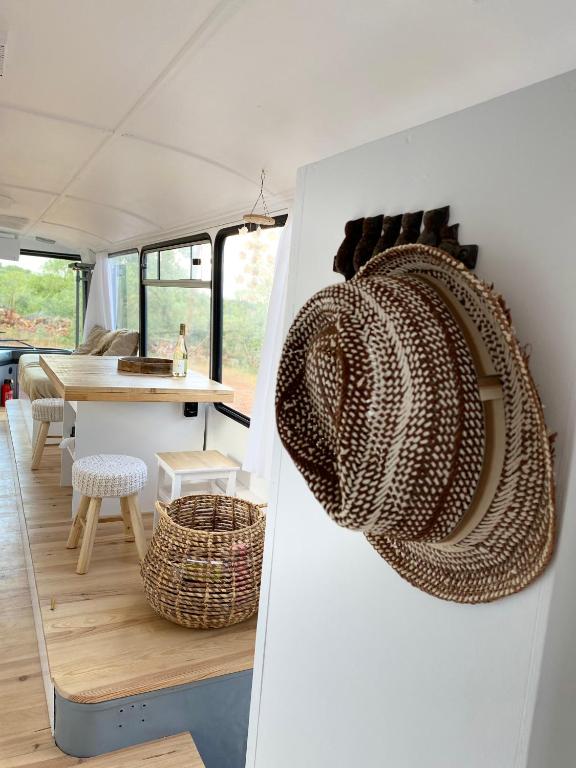 a kitchen and dining room of a caravan with a table at Glamping Algarve Olive Tree Lodge in Nora