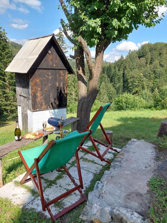 a chair and a table in front of a house at Apartmani Jarevac in Bajina Bašta