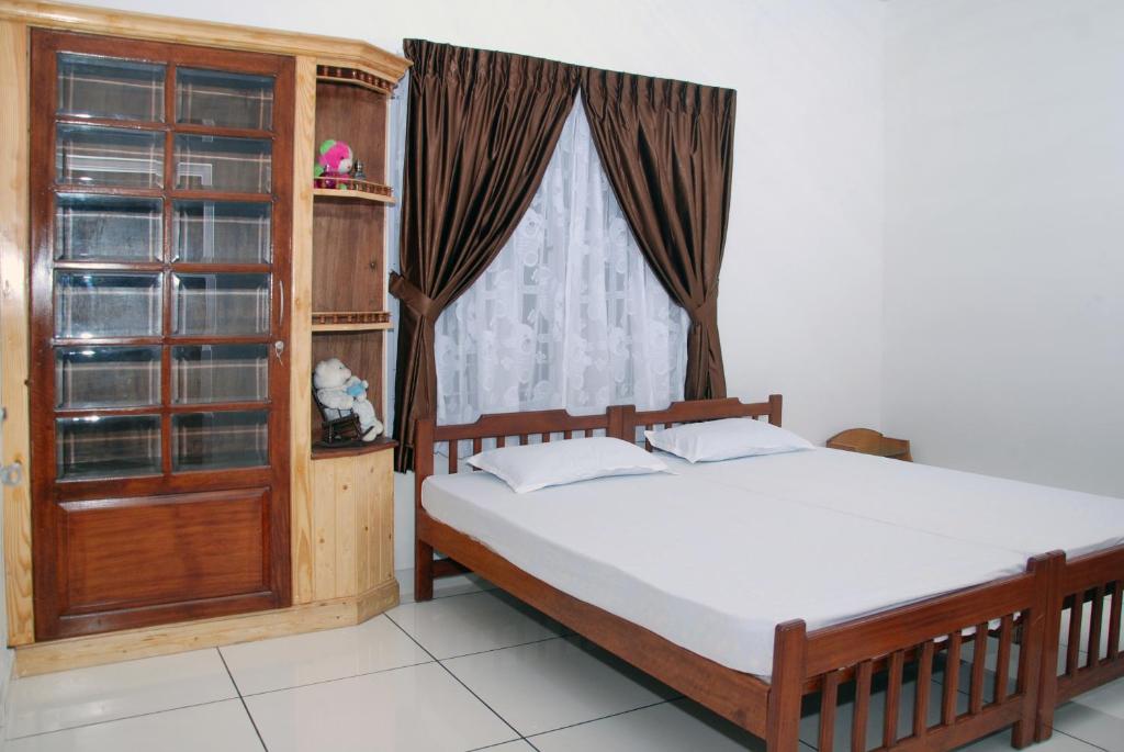 Katil atau katil-katil dalam bilik di Jojies Homestay Fortkochi
