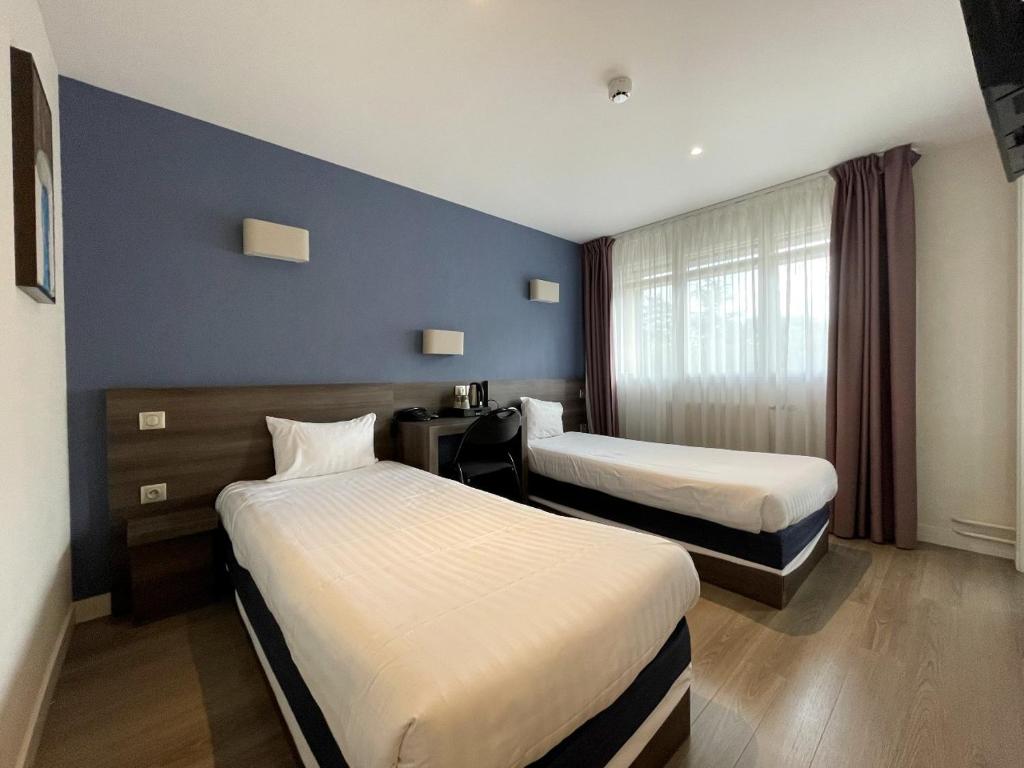 Postel nebo postele na pokoji v ubytování Hôtel Valpré