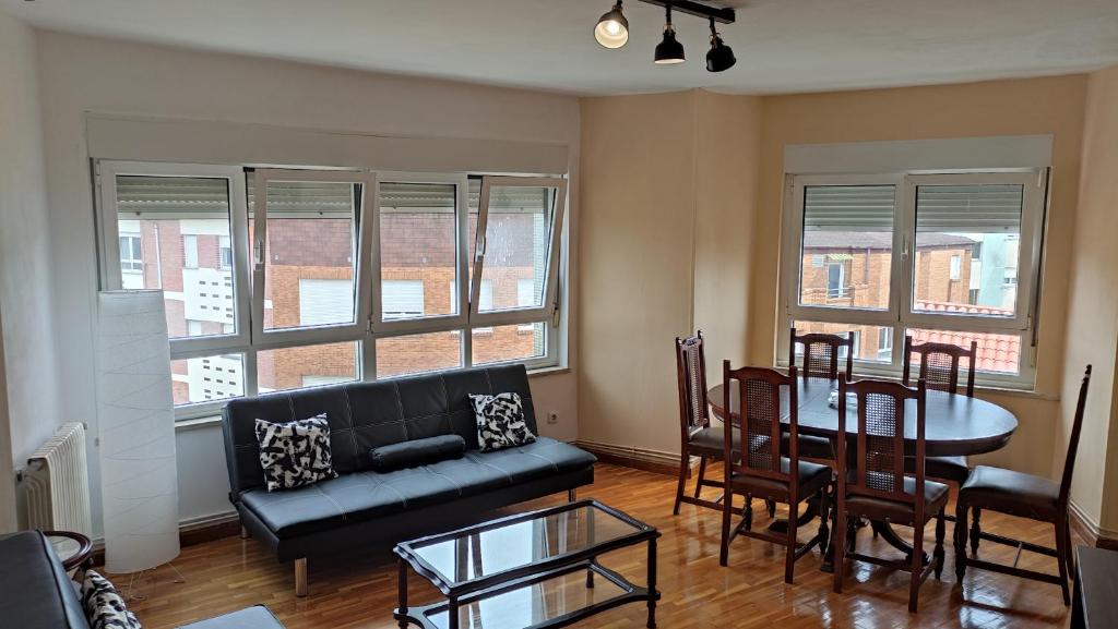 a living room with a couch and a table and chairs at Piso amplio y luminoso cerca de la playa..!! in Piedras Blancas