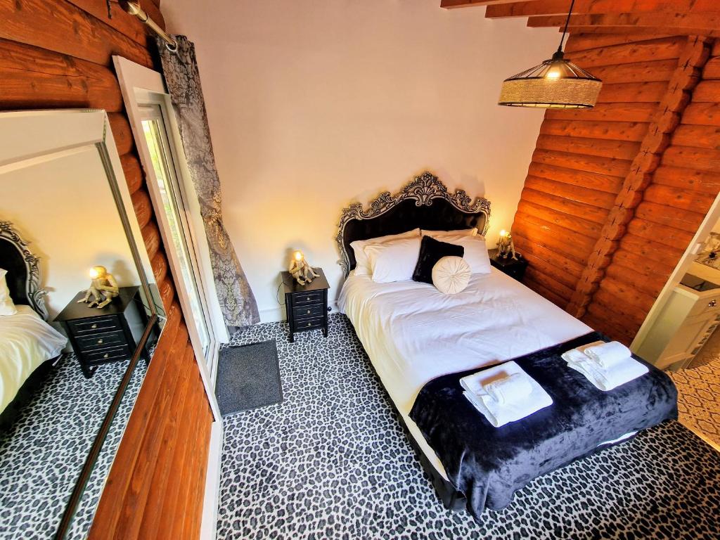 um quarto com uma cama e duas mesas de cabeceira em kaoglen Wild-Hot tub-Cairngorms-Pet Friendly em Balnald