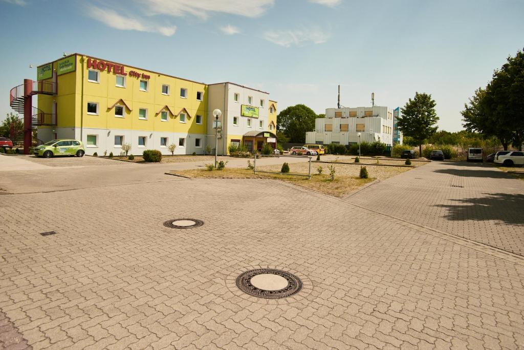 a brick road with a building and a building at Hotel City Inn in Magdeburg