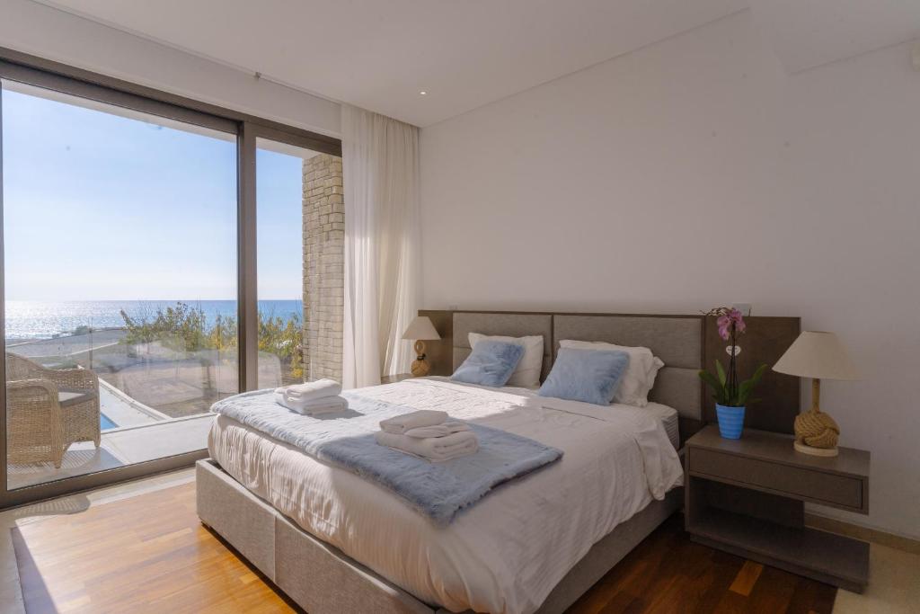 a bedroom with a large bed and a large window at Coral Residences in Coral Bay