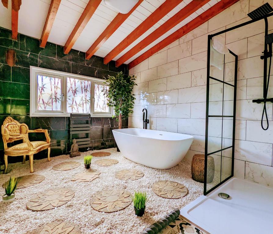 a bathroom with a tub and a glass shower at Kaoglen Zen-Feature Bath-Dunkeld-Route 500 in Balnald