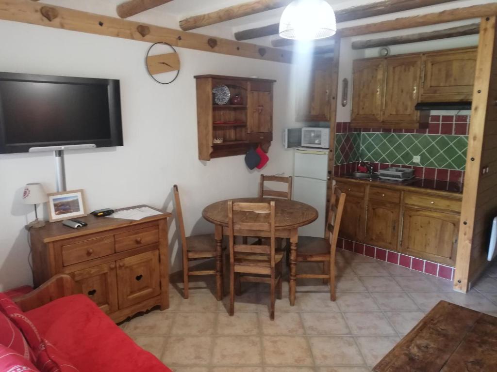 a kitchen with a table and a small kitchen with a table and chairs at GAUDISSARD A619 in Barcelonnette