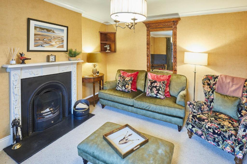 a living room with a couch and a fireplace at Host & Stay - Sixpence Cottage in Pickering