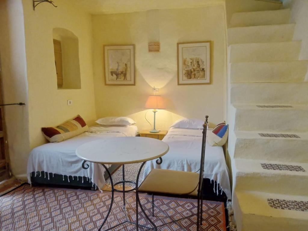 Postel nebo postele na pokoji v ubytování Hotel Dar Dhiafa