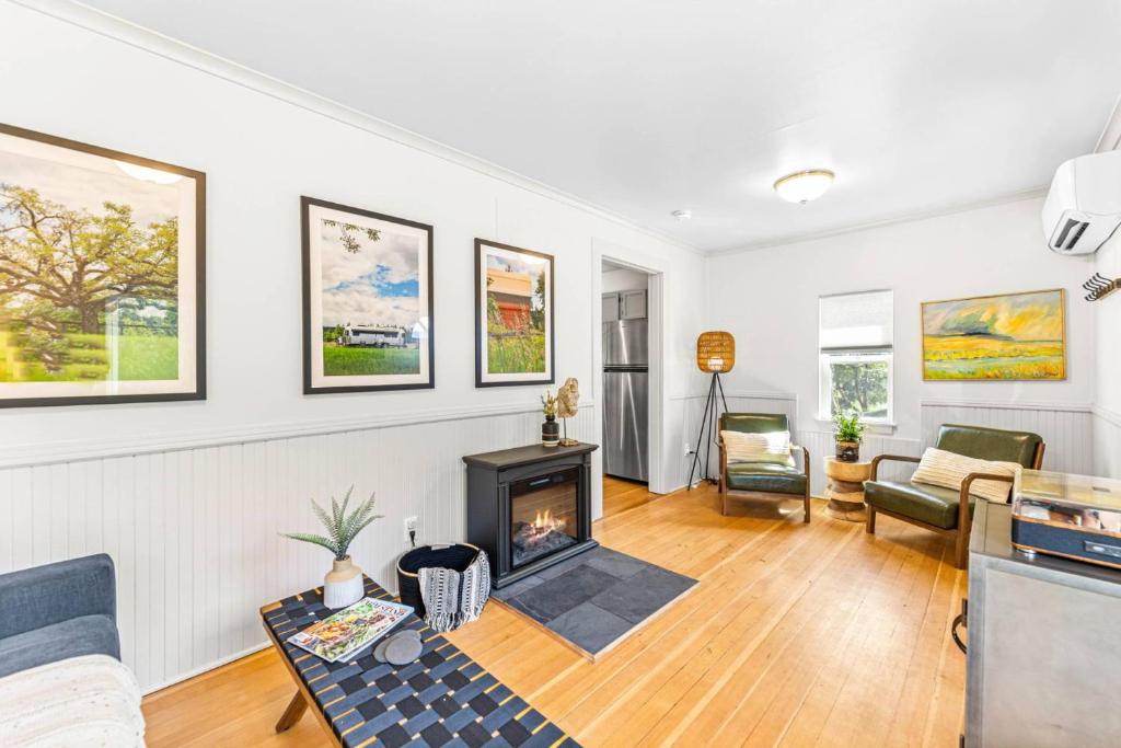 a living room with a fireplace and a couch at The Cottage On Wilsonville Road in Wilsonville