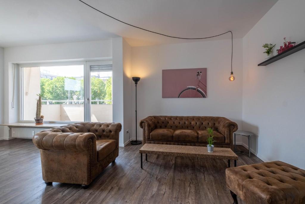 ein Wohnzimmer mit 2 Sofas und einem Tisch in der Unterkunft Spacious Flat in Karlsruhe