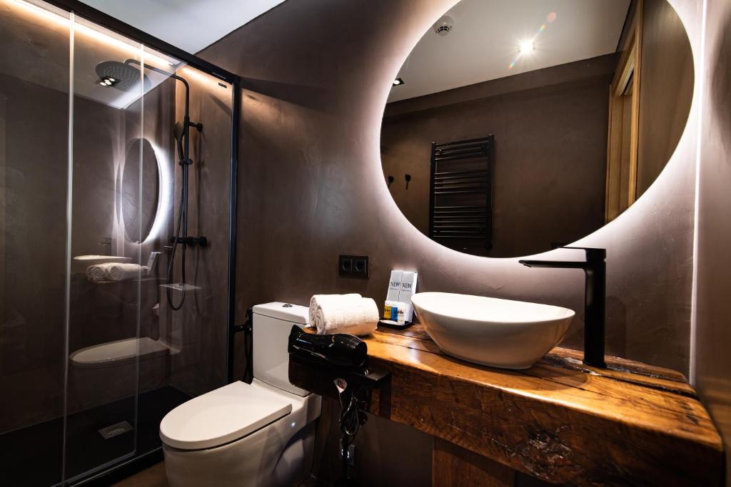 a bathroom with a sink and a mirror at Hotel Atari in Donostia-San Sebastián