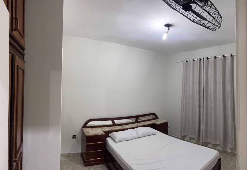 a small bedroom with a bed and a window at Apartamento a 200m da Praia do Morro com Wifi in Guarapari
