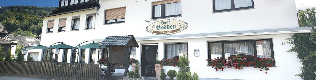 a white building with a sign on the front of it at Garni Hotel Bodden in Gummersbach