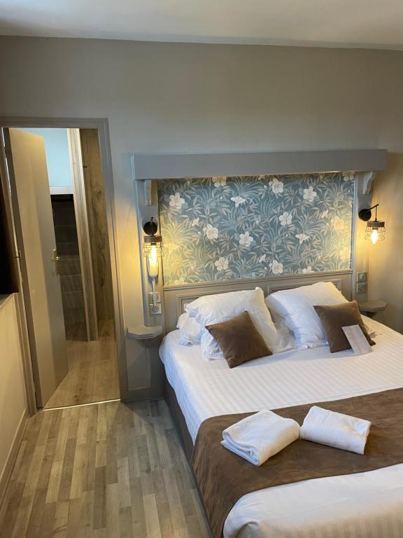 Ένα ή περισσότερα κρεβάτια σε δωμάτιο στο Logis Hôtel- Restaurant Le Relais Guillaume de Normandy