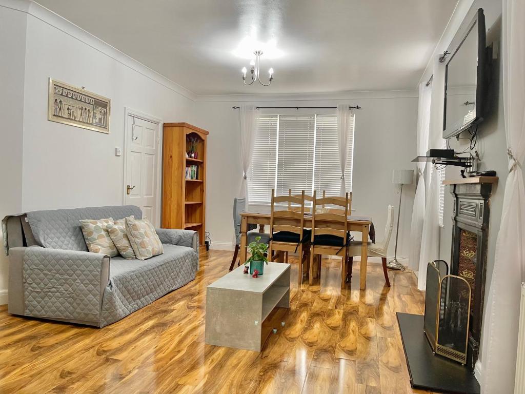 a living room with a couch and a table at Penny Lein Apartments in Uxbridge