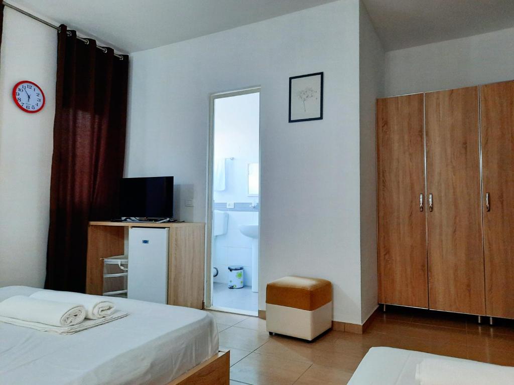 a bedroom with two beds and a mirror at Apartments Alavana in Velipojë