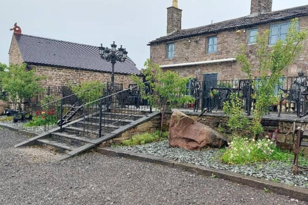 a house with a staircase in front of a building at 2-Bed Apartment near Buxton Outstanding Location in Buxton
