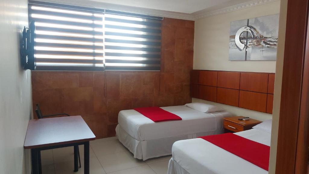 Postel nebo postele na pokoji v ubytování Hotel Murali - Cerca del Aeropuerto de Guayaquil
