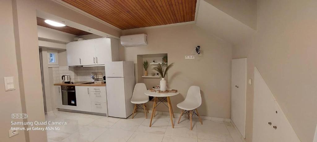 a small kitchen with a table and chairs in it at Elise Corfu City Apartment in Ágios Rókkos