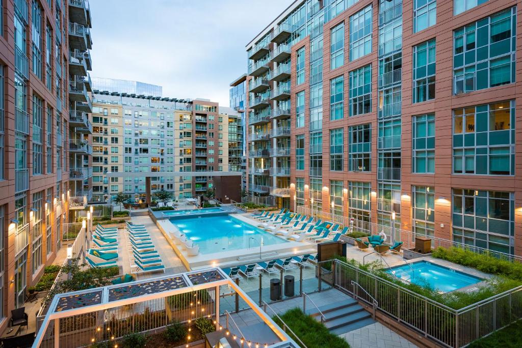 an apartment patio with a swimming pool and buildings at Sentral Union Station in Denver