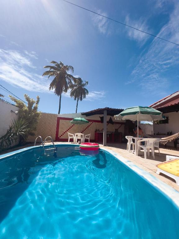 a large swimming pool with a red frisbee in it at Pousada Harmonia in Tamandaré