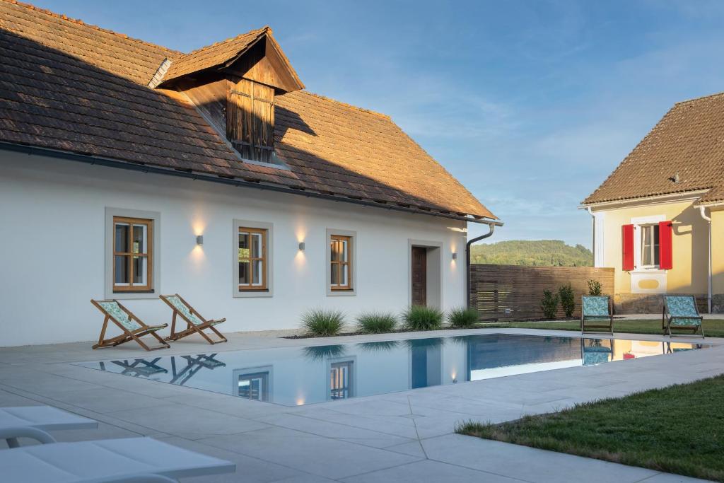 a house with a swimming pool in front of a house at Haselmühle in Sichauf