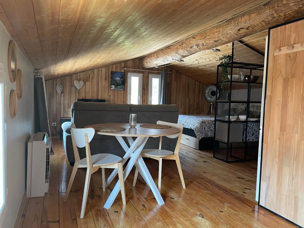 a dining room with a table and chairs in a room at Sublime studio de caractère ,50 m2 climatisé . in Montlaur-en-Diois