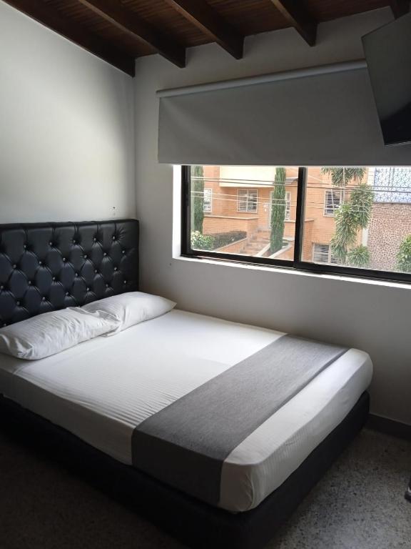 Postel nebo postele na pokoji v ubytování Hotel Urbano 70