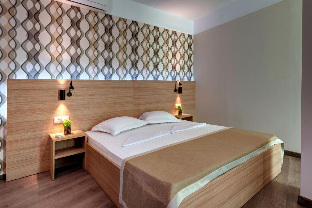 A bed or beds in a room at Maria Palace Hotel - All Inclusive