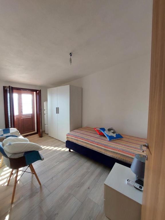 Postel nebo postele na pokoji v ubytování Attico Panoramico Baunei