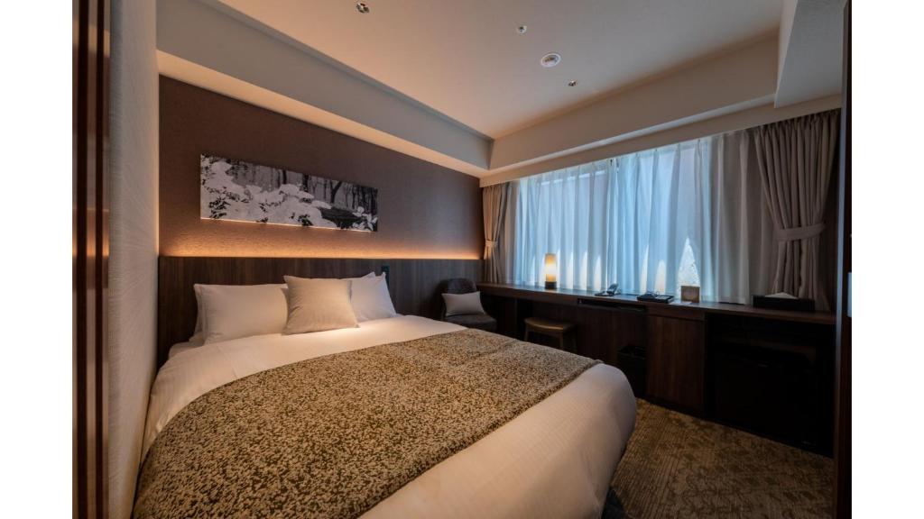 a hotel room with a bed and a window at Iroha Grand Hotel Kintetsu Nara Ekimae in Nara