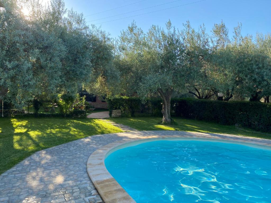 a swimming pool in a yard with trees at Villa Pantalica lato Sortino in Sortino
