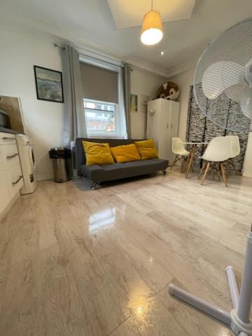 a living room with a couch with yellow pillows at Bell street in London