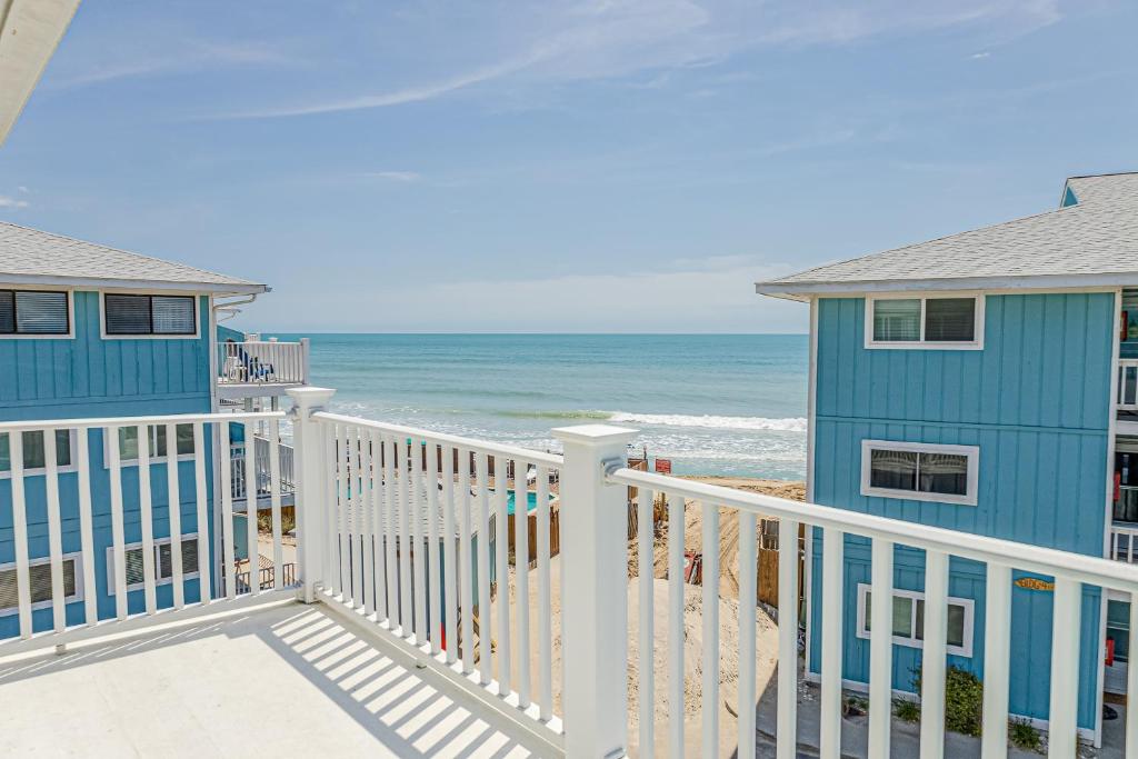 a view of the beach from the balcony of a beach house at Sea Spray Place in Kure Beach