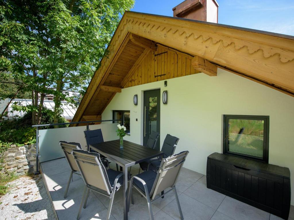 d'une terrasse avec une table et des chaises en bois. dans l'établissement Kobelhäusl bei Hause - Yannick, à Neukirchen am Großvenediger