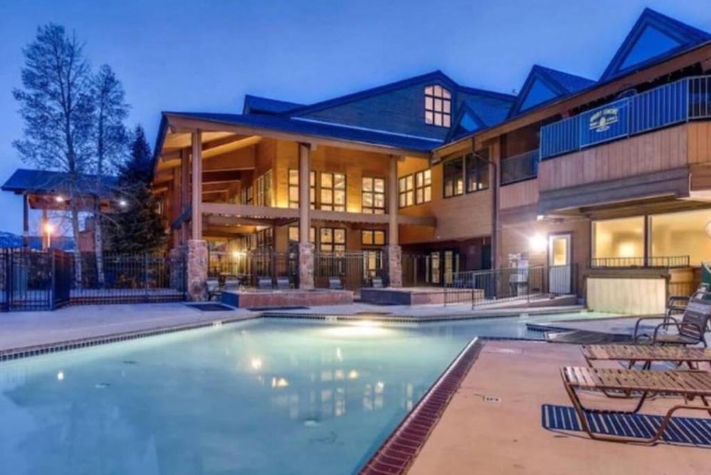 a large house with a swimming pool in front of it at K-Suite-Mt View-Resort-Pool-Hot Tub-Near RMNP & WP in Granby