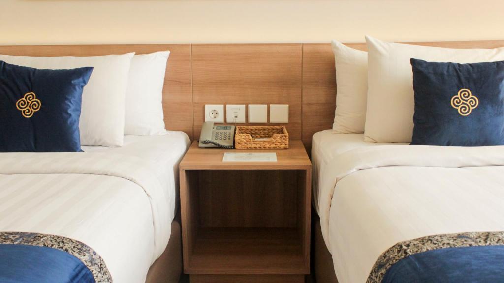 Postel nebo postele na pokoji v ubytování Antero Hotel Jababeka