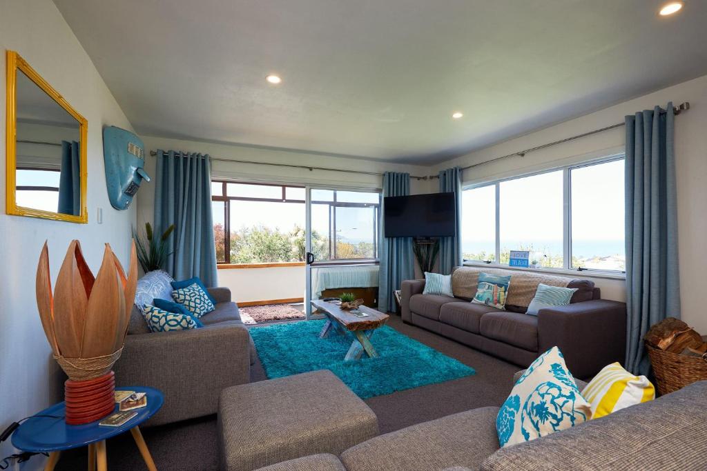 a living room with a couch and a table at Five Palms in Kaikoura