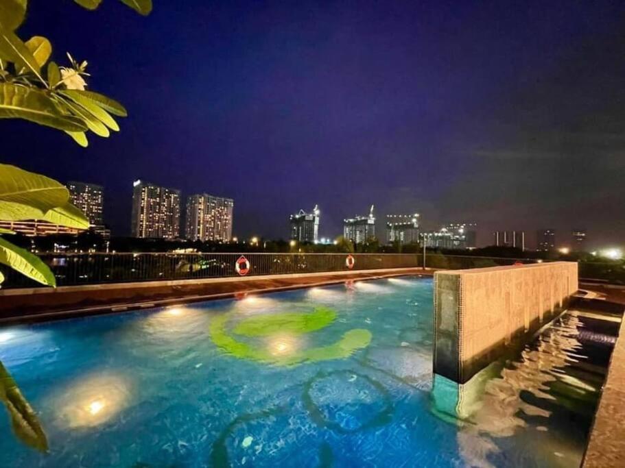 a large swimming pool with a city skyline at night at Thóc Ecopark blue home-1 bed room in Cong Luận