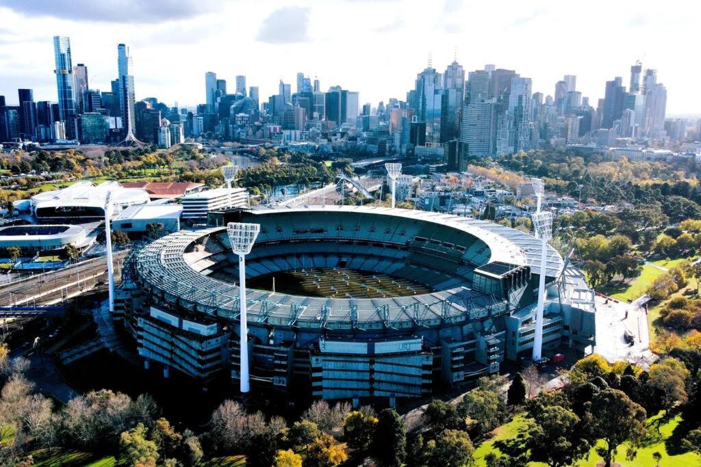 Hotel East Melbourne 1BR - Close to the MCG, an aerial view of a stadium with a city at East Melbourne 1BR - Close to the MCG in Melbourne