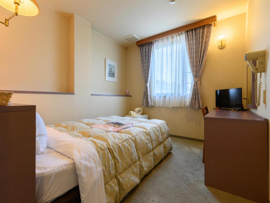 Postel nebo postele na pokoji v ubytování Tabist Station Hotel Isobe Ise-Shima