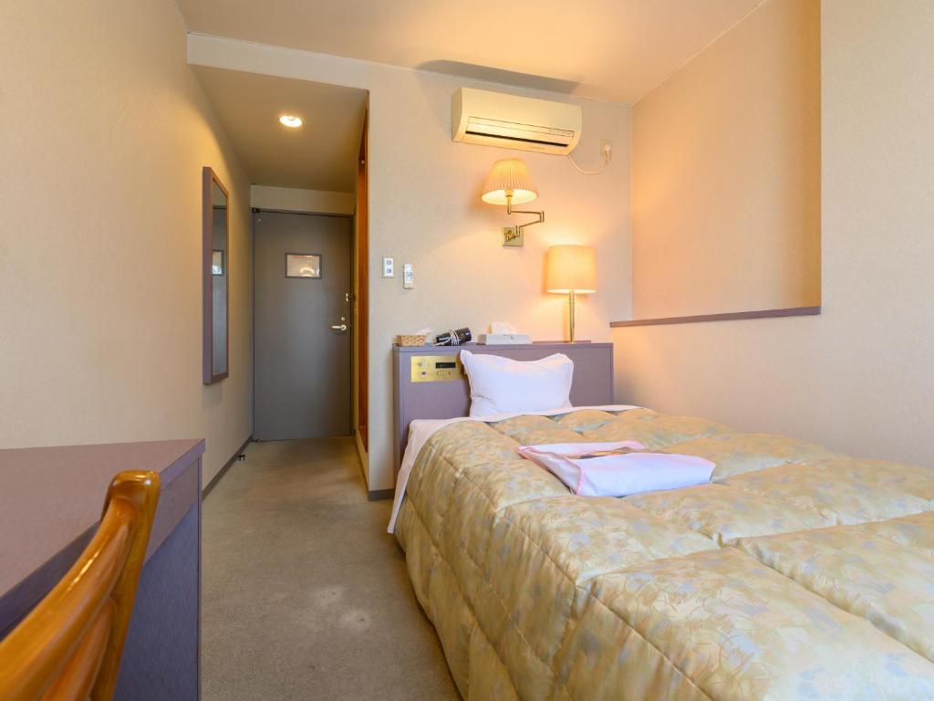 Postel nebo postele na pokoji v ubytování Tabist Station Hotel Isobe Ise-Shima