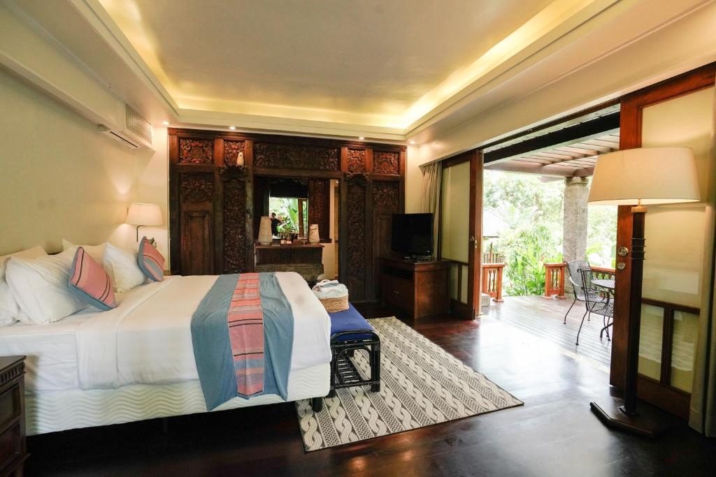 Postel nebo postele na pokoji v ubytování Umah Lawas Villa Ubud