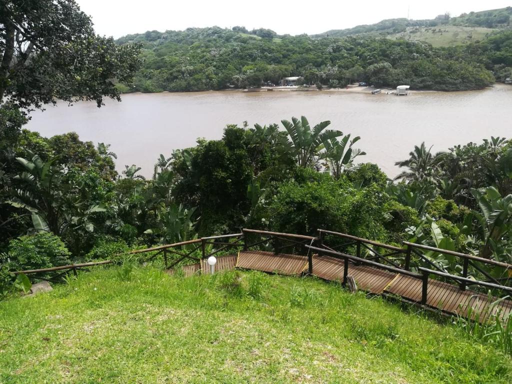 a bridge over a river next to a body of water at 17 MONTEGO BAY CARIBBEAN ESTATES in Port Edward