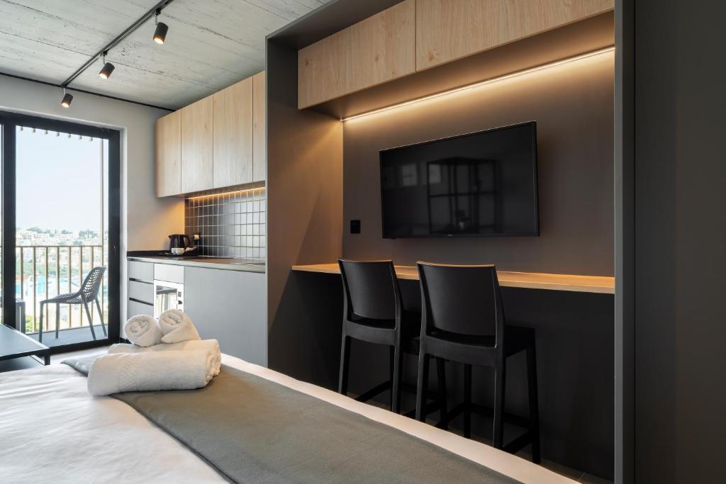 TV a/nebo společenská místnost v ubytování Aparthotel Adagio Malta Central