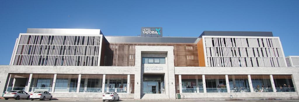 a building with cars parked in front of it at Hotel Yayoba in Tekirdag