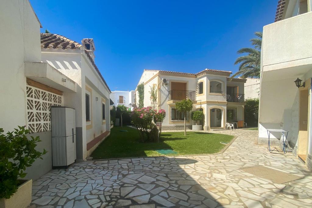 a large house with a yard with a driveway at Infinity Resort Vera Beach Clara in Los Amarguillos