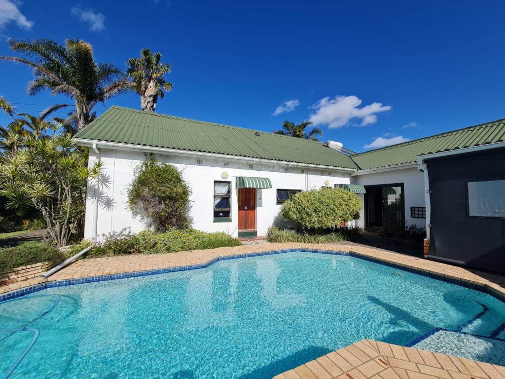 a swimming pool in front of a house at The Hide on Tindale in East London